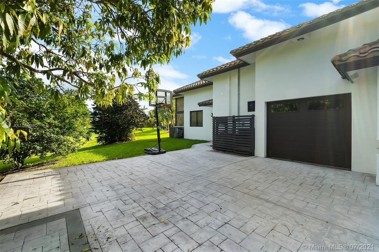 2850 Windmill Ranch Road Weston, FL 33331 - Photo 47 of 50 a view of a house with a yard and garage