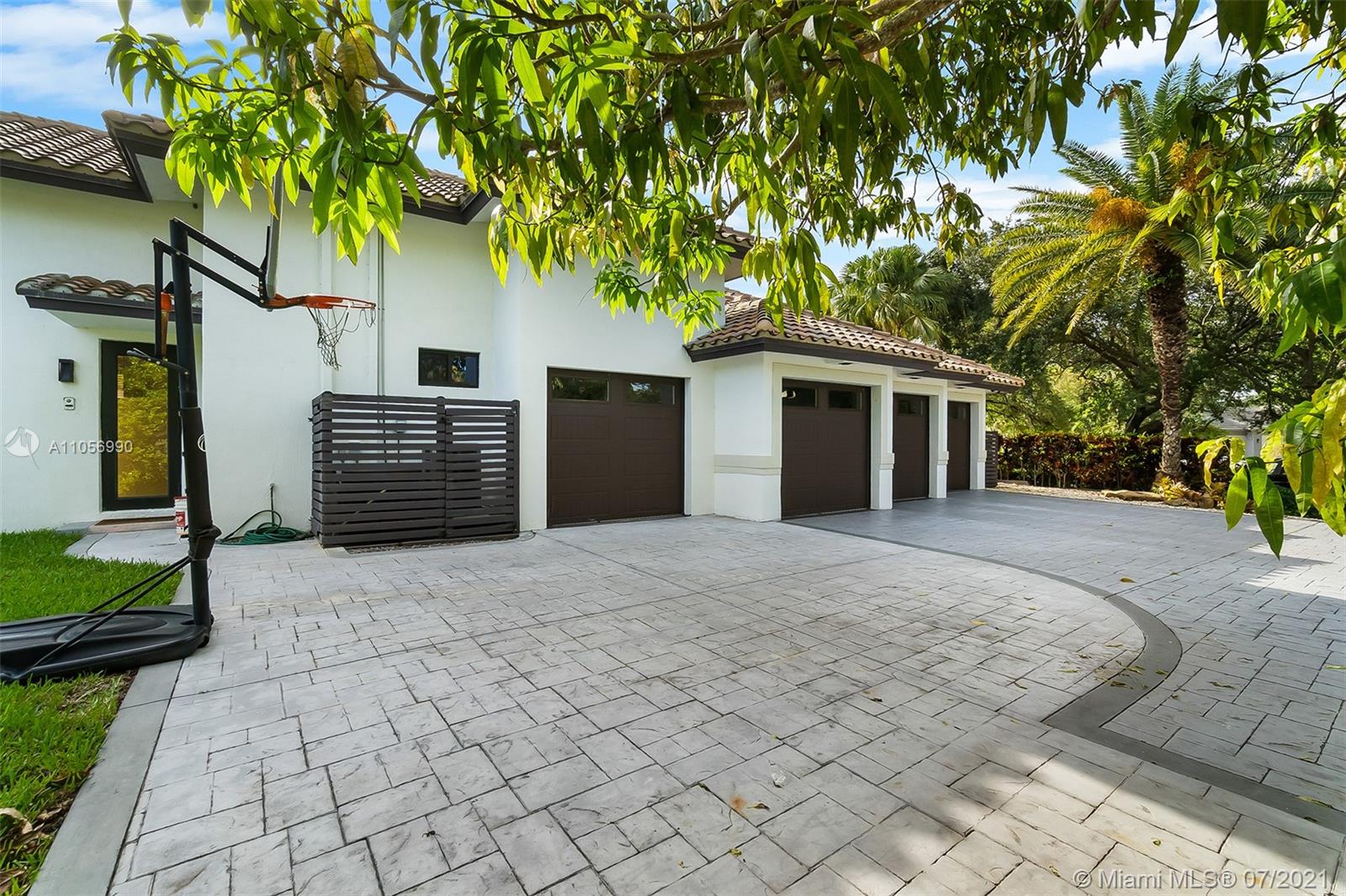 2850 Windmill Ranch Road Weston, FL 33331 - Photo 48 of 50 a front view of a house with a yard and a garden