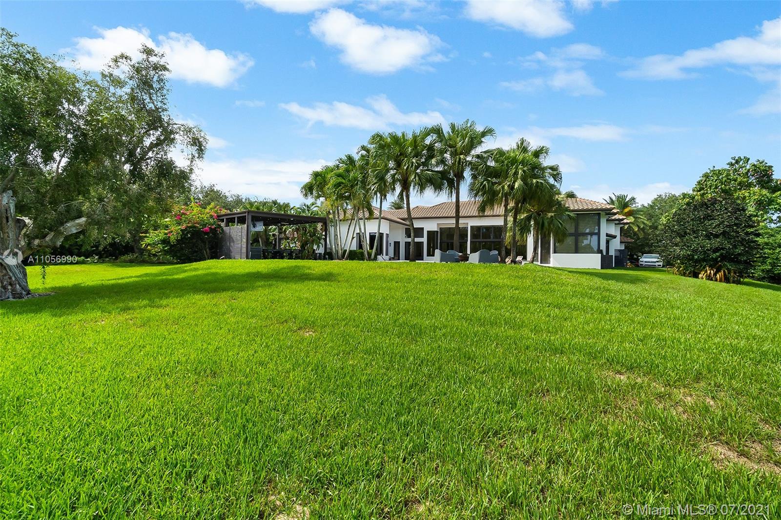 2850 Windmill Ranch Road Weston, FL 33331 - Photo 50 of 50 a view of a building with a big yard and large trees