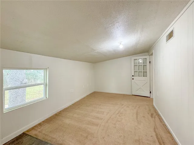 a view of an empty room and window