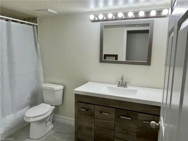a bathroom with a sink a toilet and bathtub