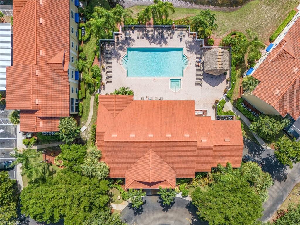 8224 Key Royal Circle, Unit 211 Naples, FL 34119 - Photo 15 of 25 an aerial view of a house with a garden and a yard