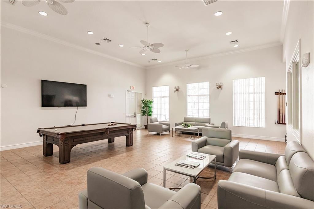 8224 Key Royal Circle, Unit 211 Naples, FL 34119 - Photo 22 of 25 a living room with furniture and a flat screen tv
