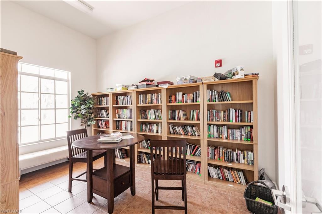 8224 Key Royal Circle, Unit 211 Naples, FL 34119 - Photo 23 of 25 a workspace with furniture and a book shelf