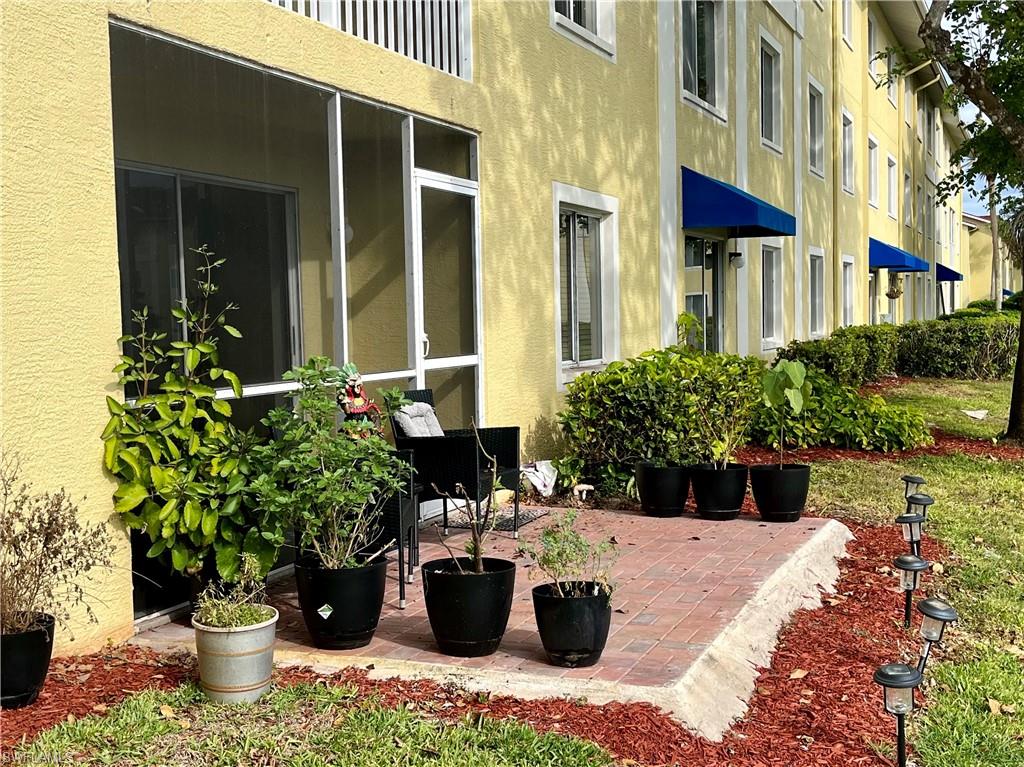 8224 Key Royal Circle, Unit 211 Naples, FL 34119 - Photo 6 of 21 Screened porch and extended brick paver patio.