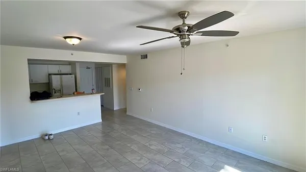 a view of empty room with a ceiling fan