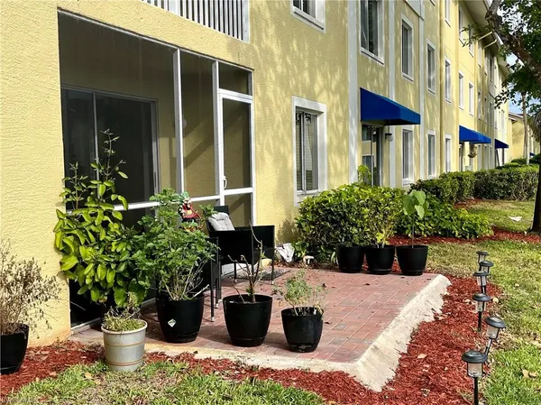 a view of building with river in front of house