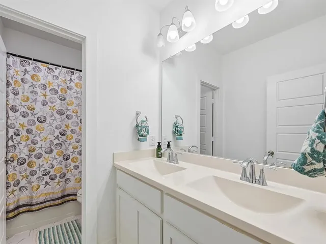 a bathroom with a sink double vanity and a mirror