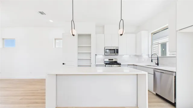 a kitchen with a sink and cabinets