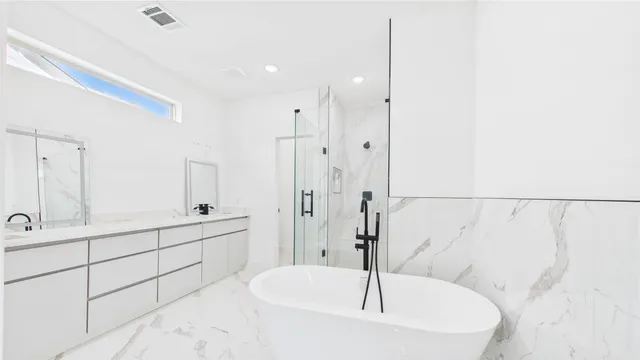 a spacious bathroom with a bathtub and a shower