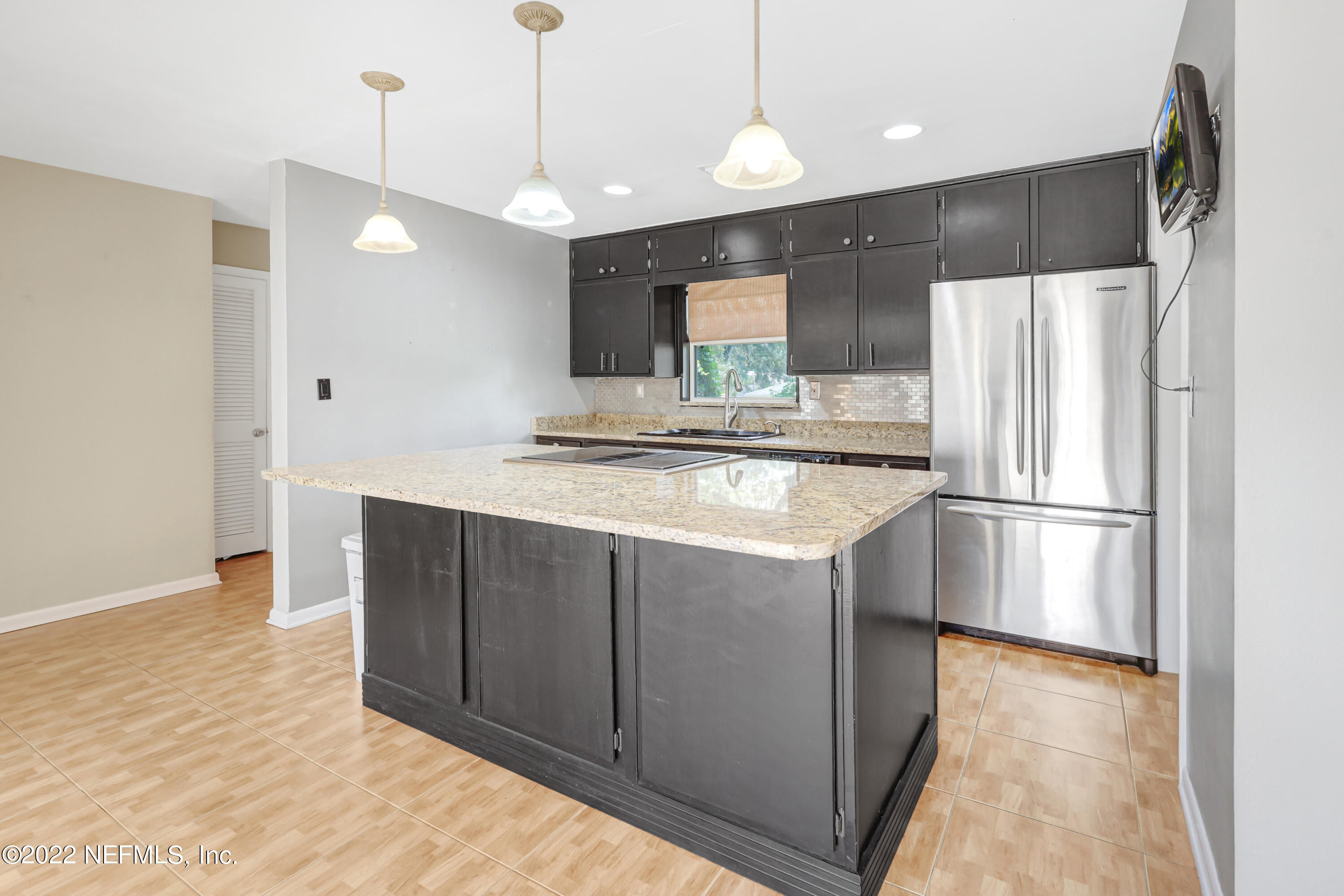 3955 Heidi Road Jacksonville, FL 32277 - Photo 12 of 43 a kitchen with stainless steel appliances a refrigerator and a sink