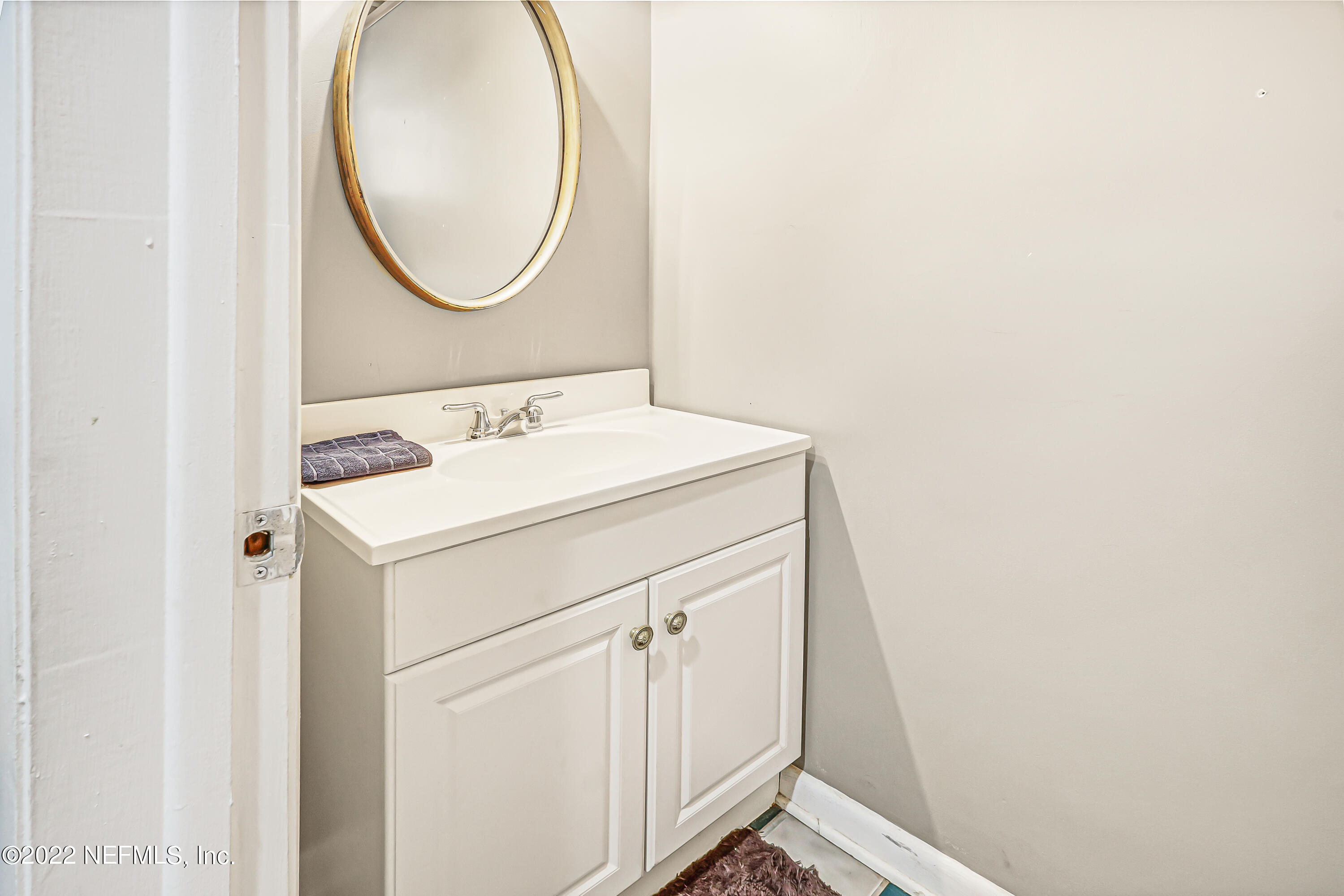 3955 Heidi Road Jacksonville, FL 32277 - Photo 17 of 43 a bathroom with a sink and a mirror