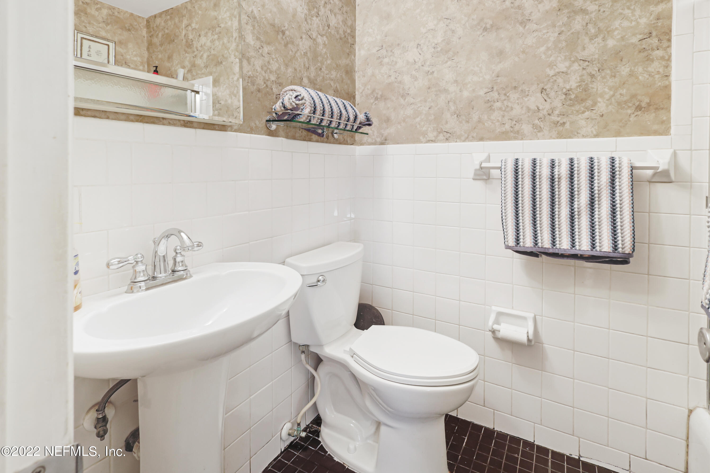 3955 Heidi Road Jacksonville, FL 32277 - Photo 19 of 43 a white toilet sitting next to a bathroom sink