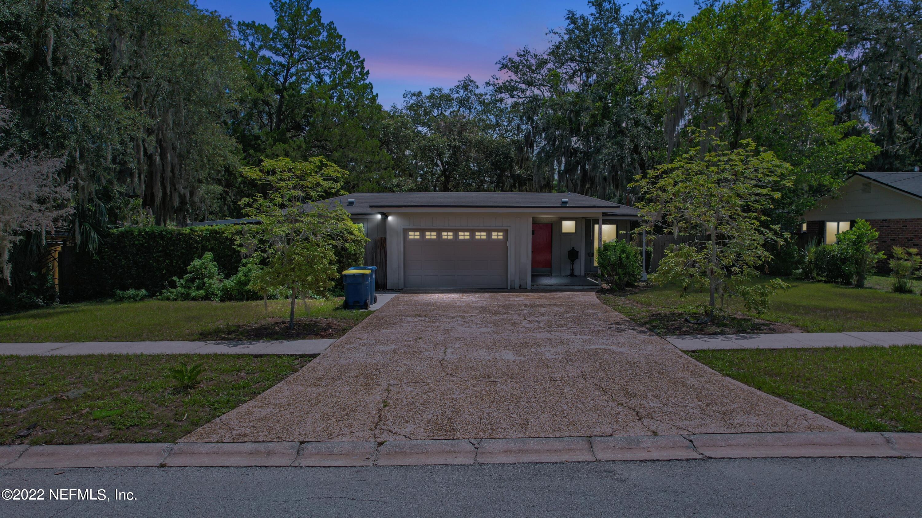 3955 Heidi Road Jacksonville, FL 32277 - Photo 2 of 43 a front view of a house with a yard and garden
