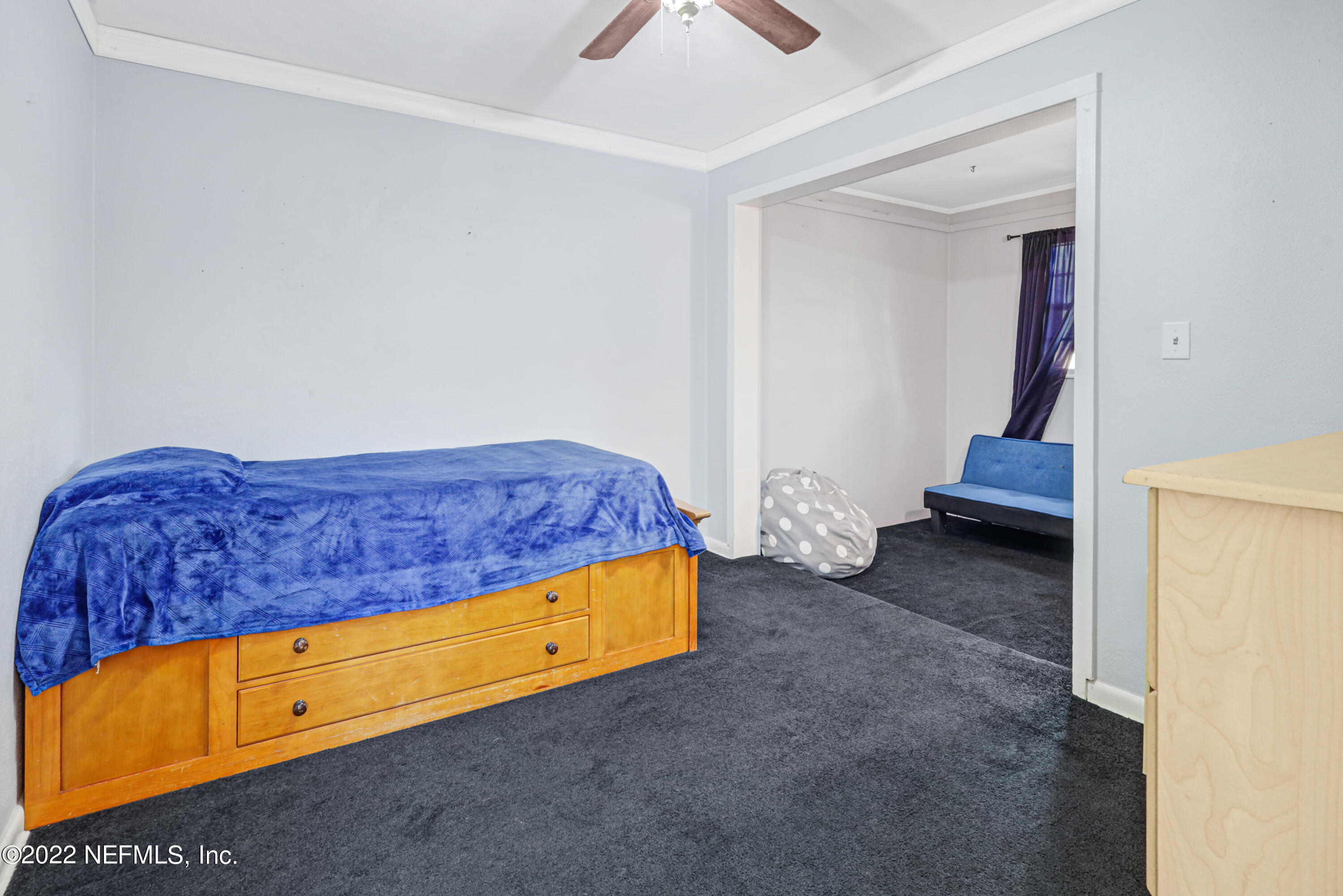 3955 Heidi Road Jacksonville, FL 32277 - Photo 25 of 43 a bedroom with a bed and a lamp on dresser