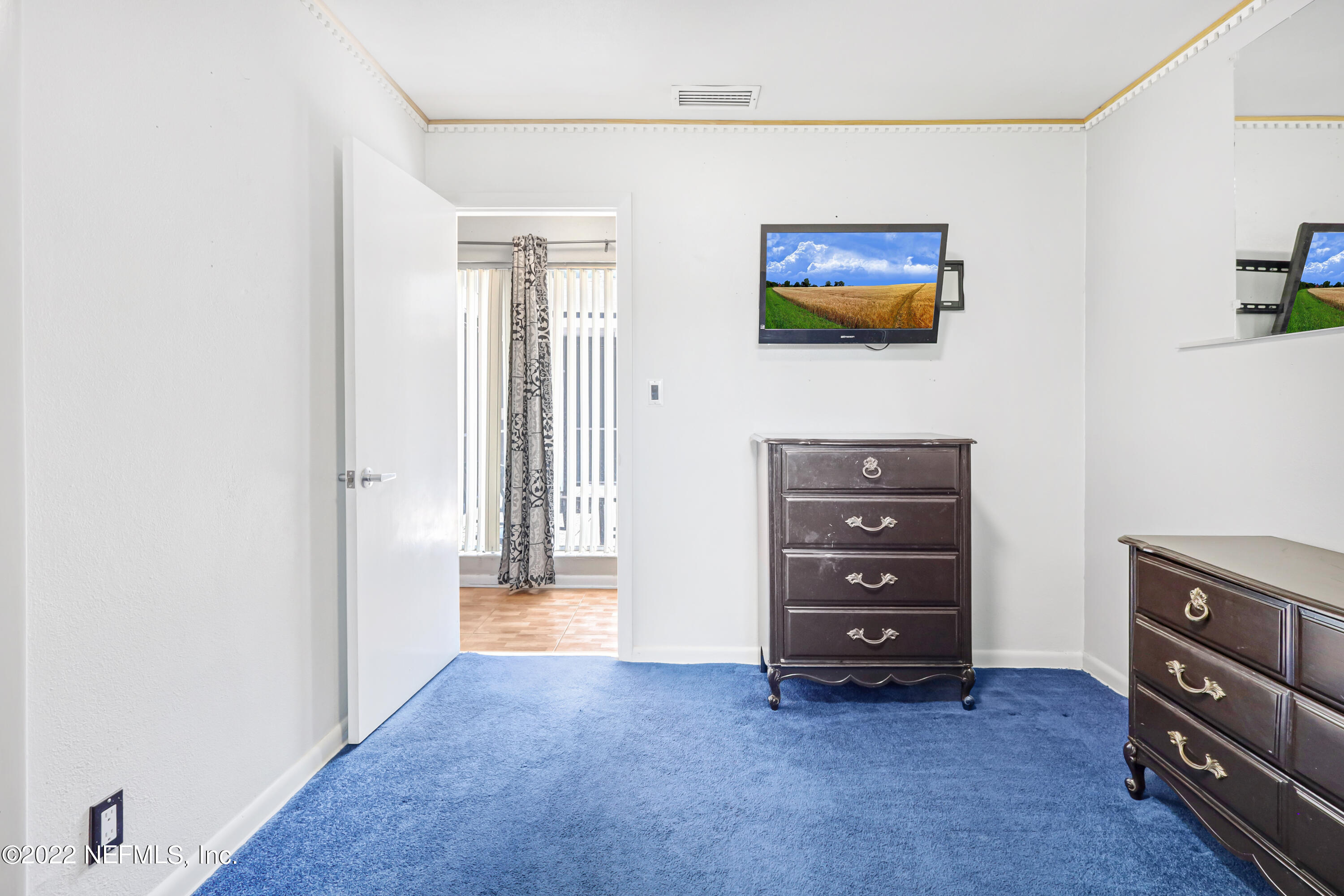 3955 Heidi Road Jacksonville, FL 32277 - Photo 28 of 43 a view of room with cabinet and flat screen tv