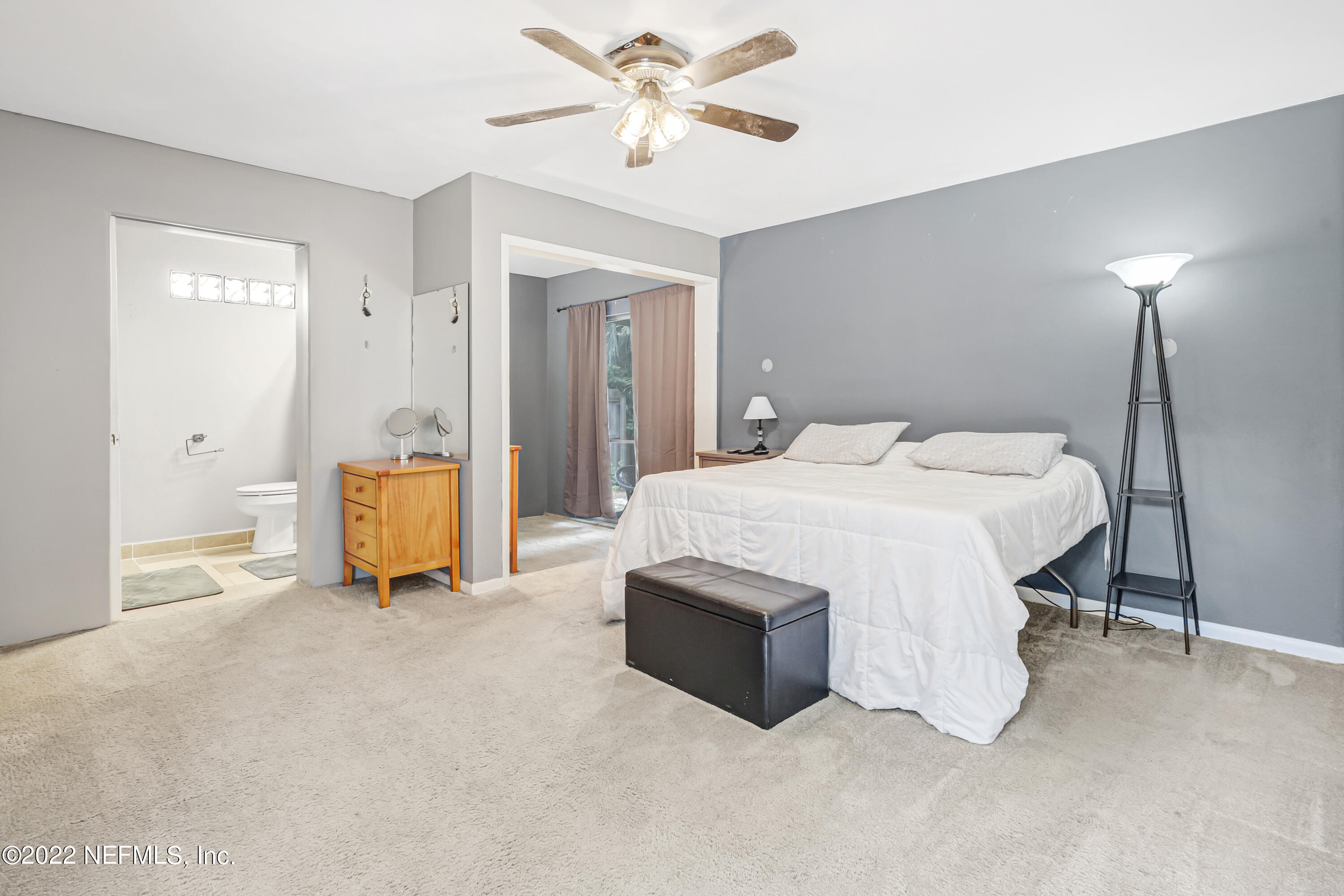3955 Heidi Road Jacksonville, FL 32277 - Photo 29 of 43 a bedroom with a bed and a chandelier