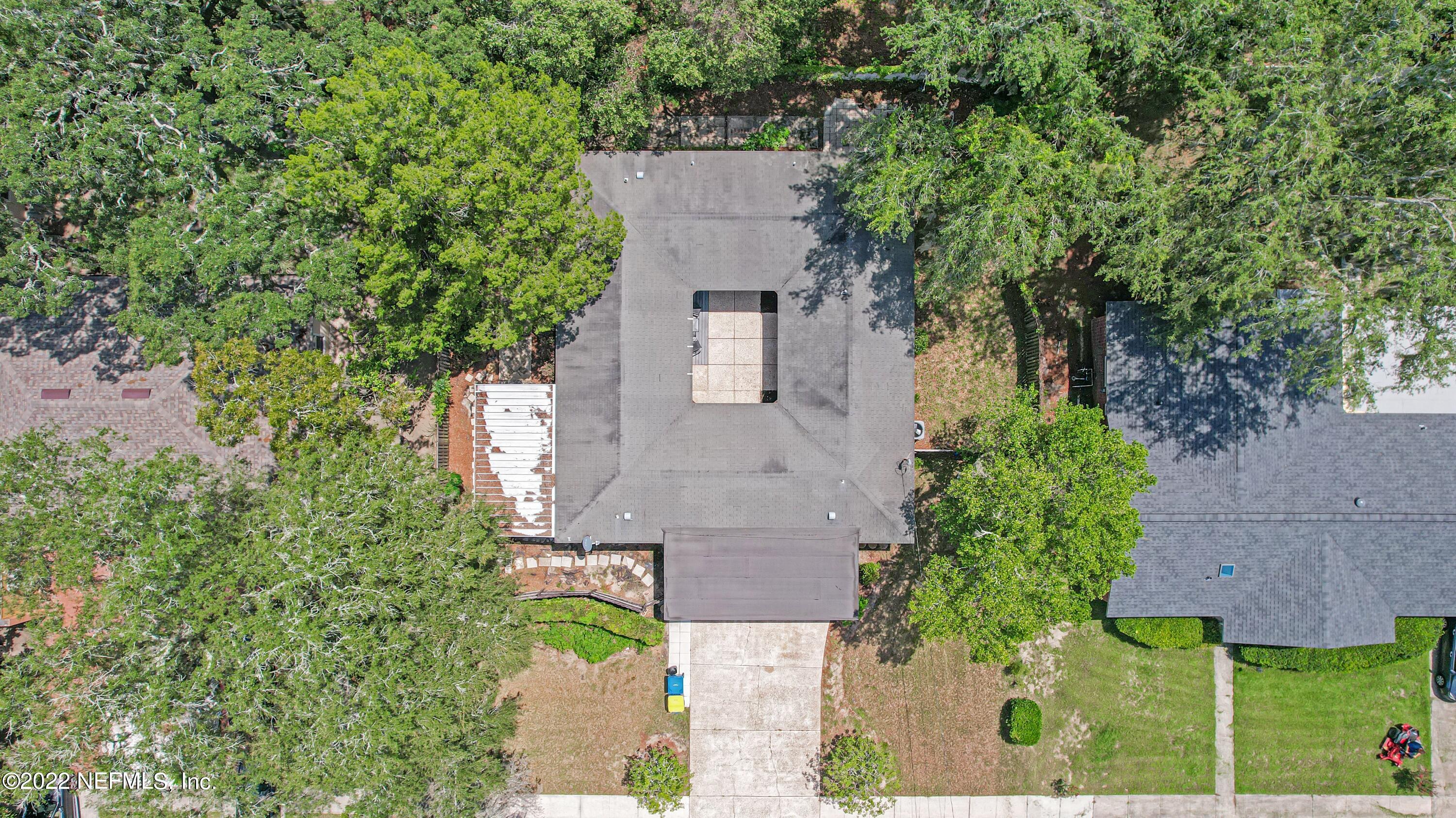 3955 Heidi Road Jacksonville, FL 32277 - Photo 3 of 43 an aerial view of a house with outdoor space and trees all around
