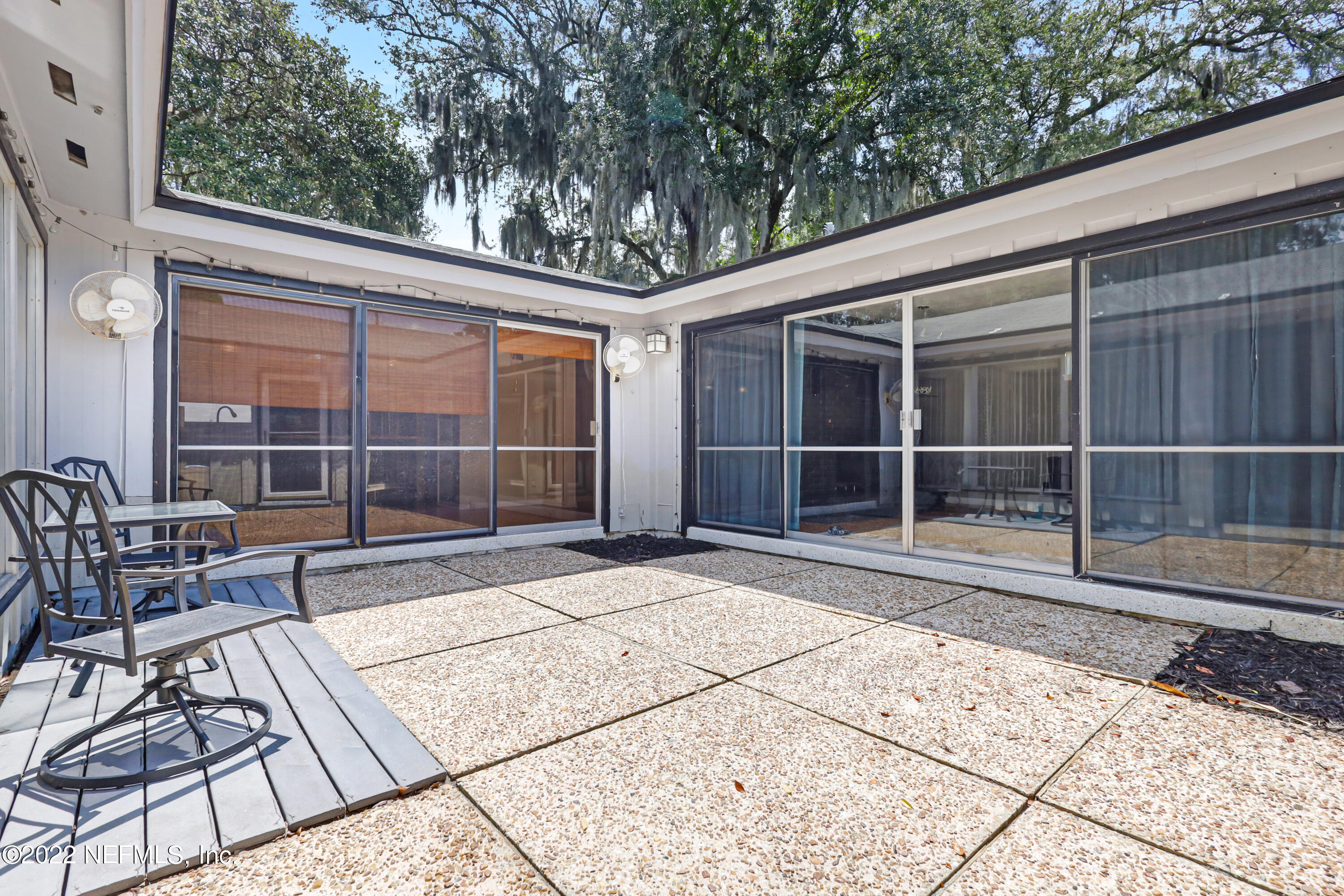 3955 Heidi Road Jacksonville, FL 32277 - Photo 34 of 43 a view of backyard with a large window and wooden fence