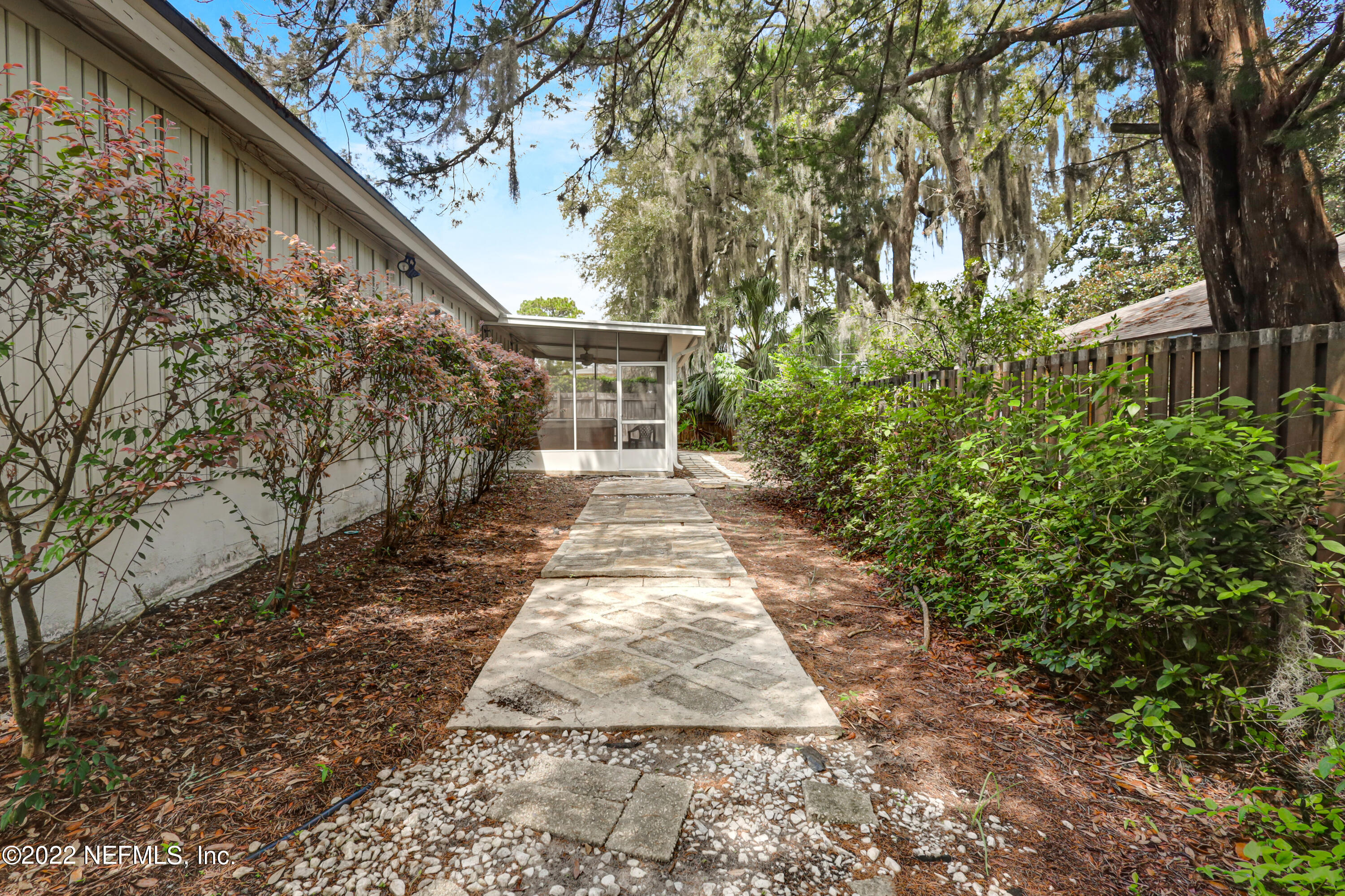 3955 Heidi Road Jacksonville, FL 32277 - Photo 39 of 43 a backyard of a house with plants and trees