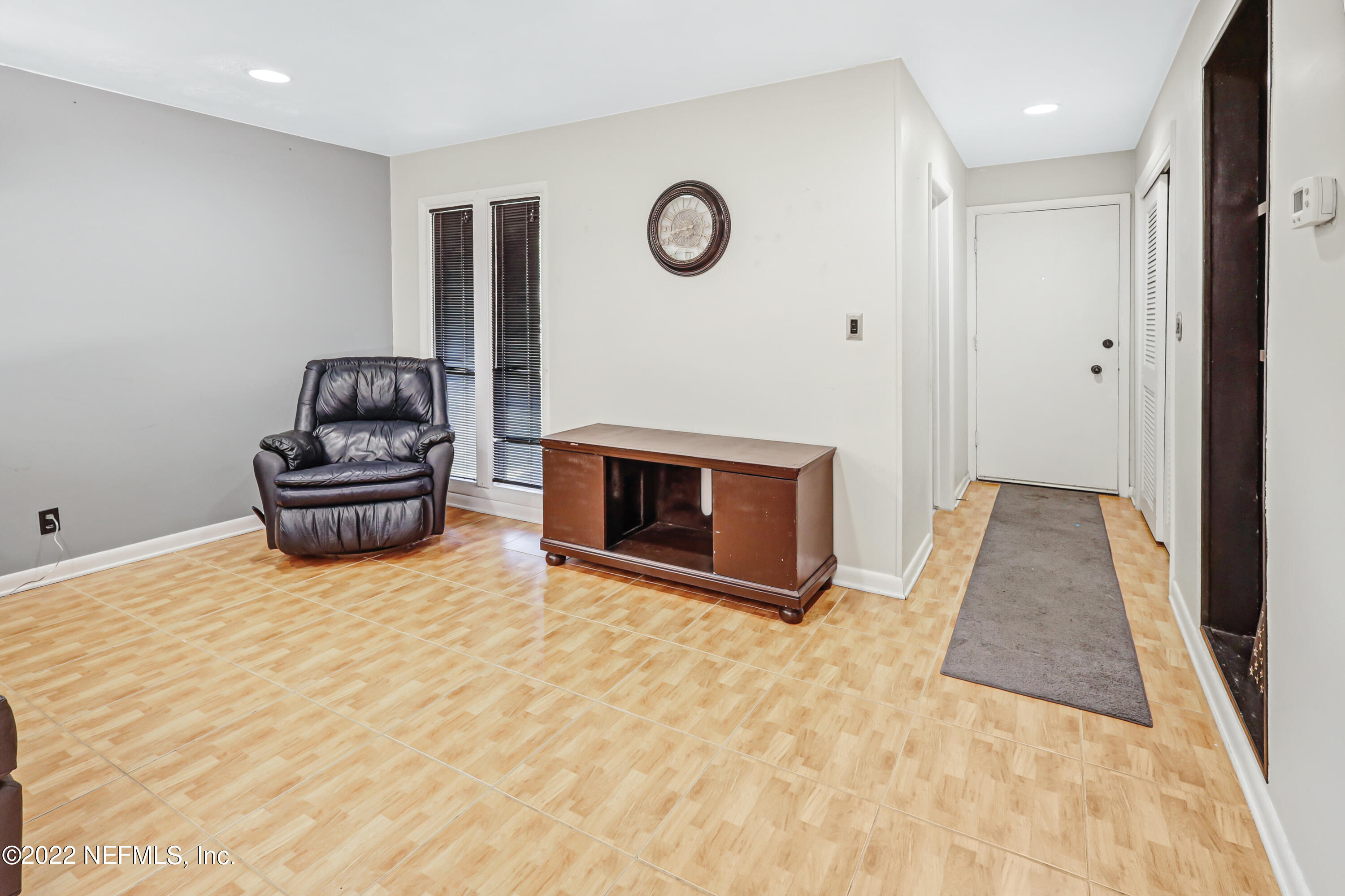 3955 Heidi Road Jacksonville, FL 32277 - Photo 6 of 43 a living room with furniture and a fireplace