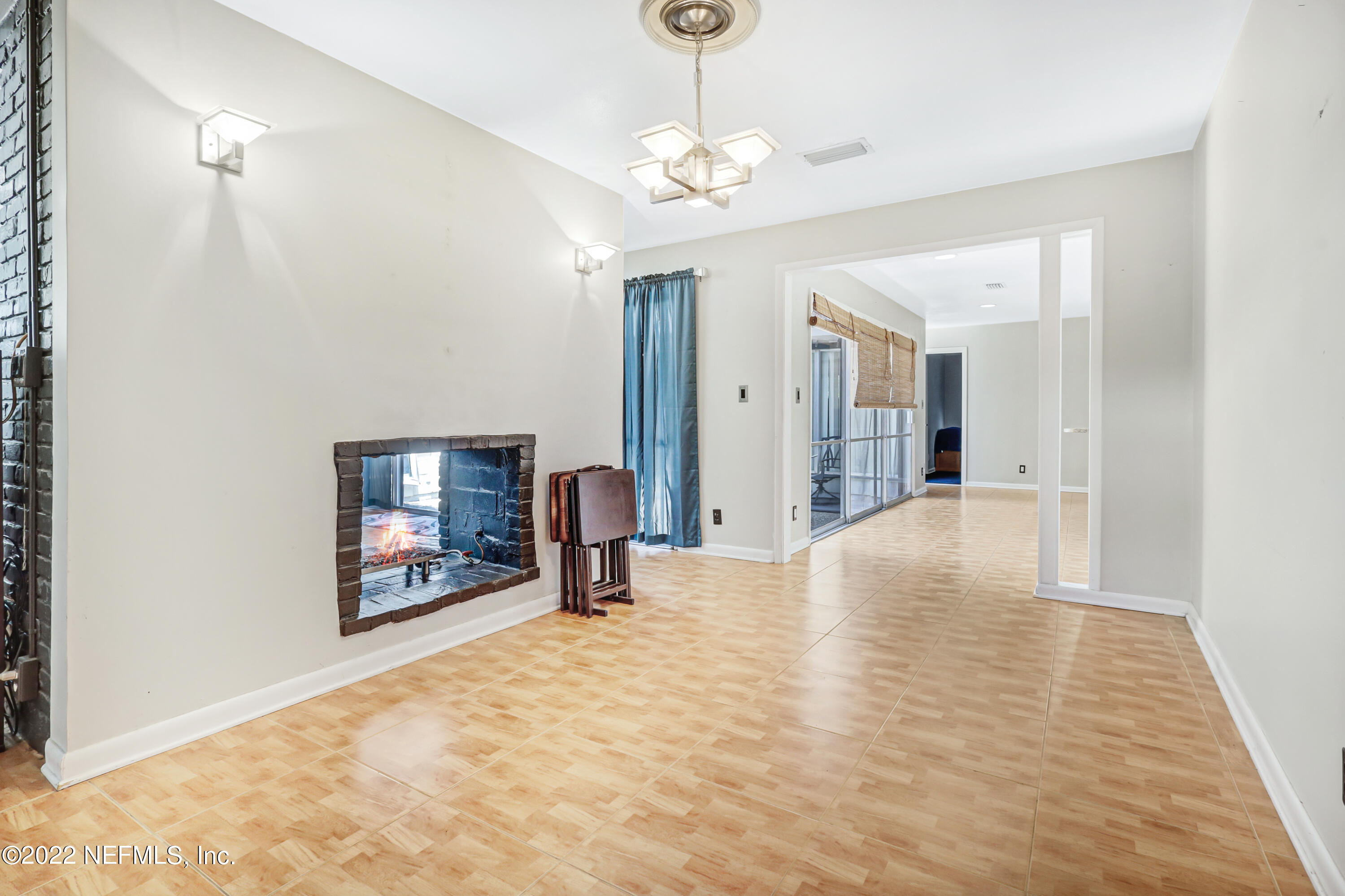3955 Heidi Road Jacksonville, FL 32277 - Photo 10 of 43 a view of a livingroom with wooden floor and a chandelier