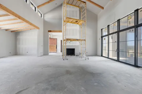 a view of an empty room with a window and closet