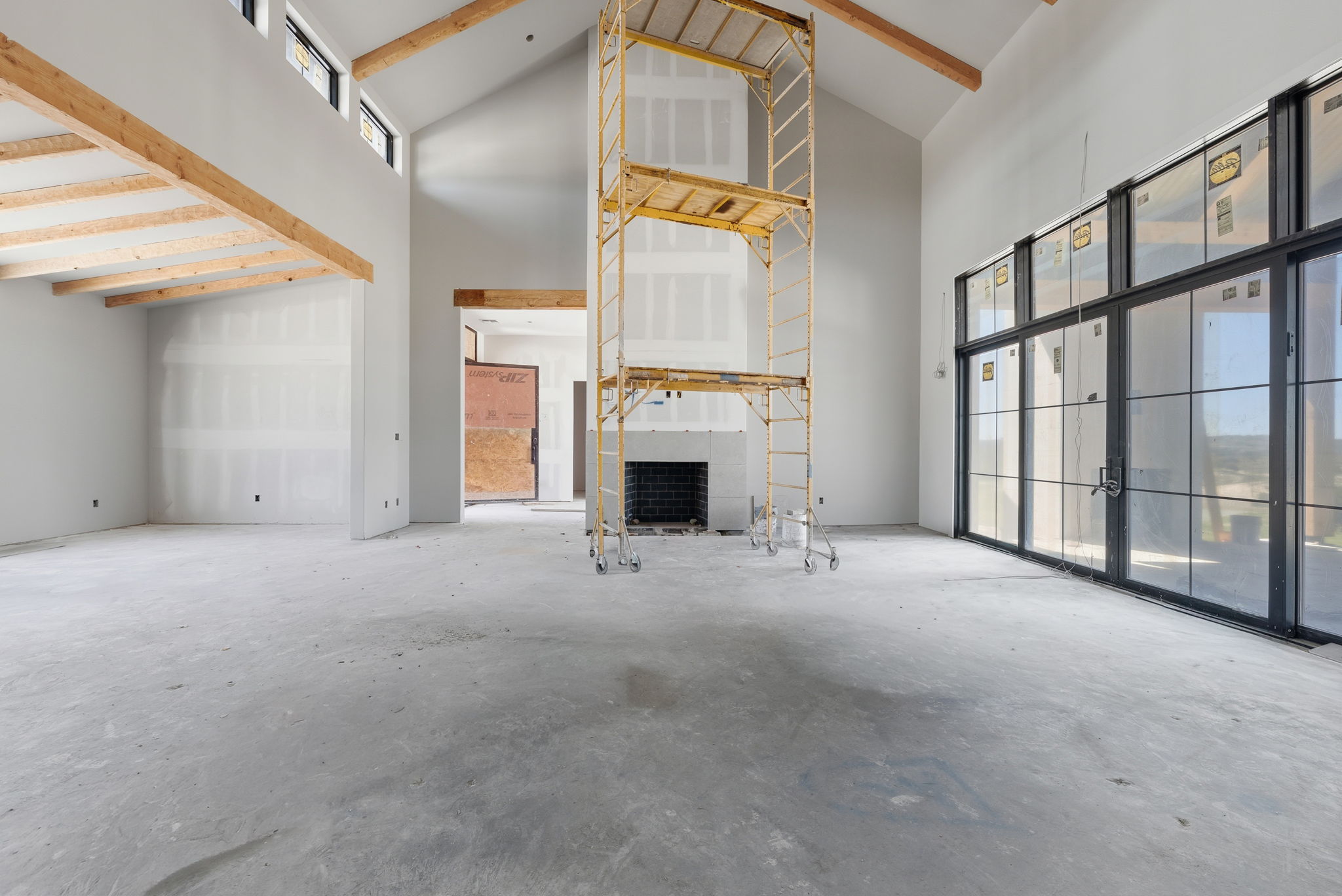 3300 Rm-165 Dripping Springs Dripping Springs, TX 78620 - Photo 13 of 25 a view of an empty room with a fireplace and a window