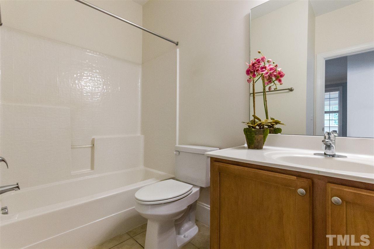 12104 McBride Drive Raleigh, NC 27613 - Photo 14 of 24 a bathroom with a sink a toilet and shower