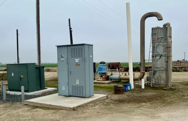 a view of a field with trees in background