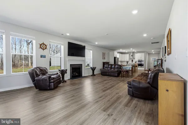 a living room with furniture a flat screen tv and a table