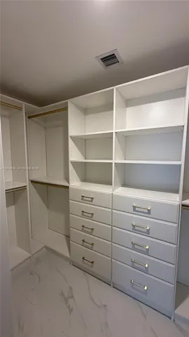 a view of an empty walk in closet