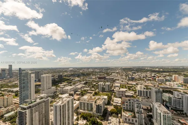a balcony with furniture and a potted plant