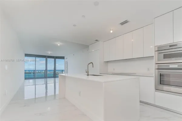 a kitchen with cabinets and white appliances