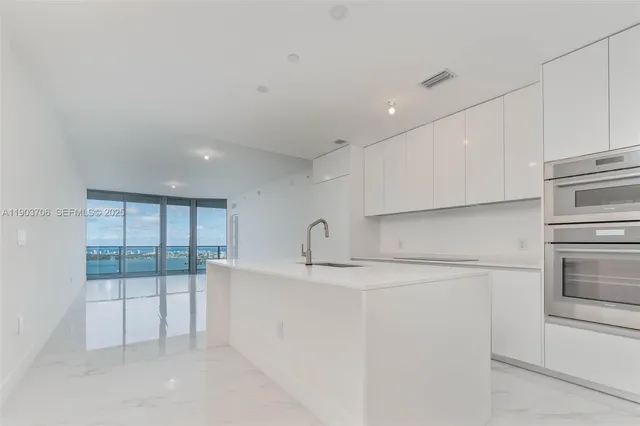 a kitchen with cabinets and white appliances