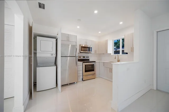 a kitchen with a refrigerator a sink and dishwasher