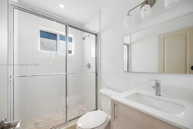 a bathroom with a sink toilet and shower