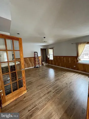 a view of kitchen and hall with wooden floor