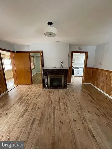 wooden floor with a window in a room