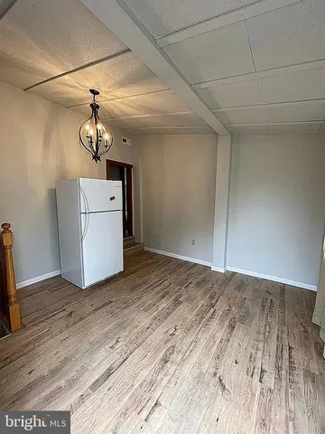 a view of a room with wooden floor