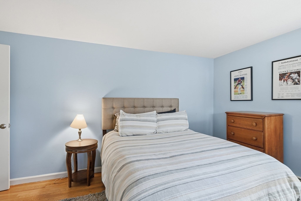 283 Forest Glen West Springfield, MA 01089 - Photo 27 of 40 a bedroom with a bed and a lamp