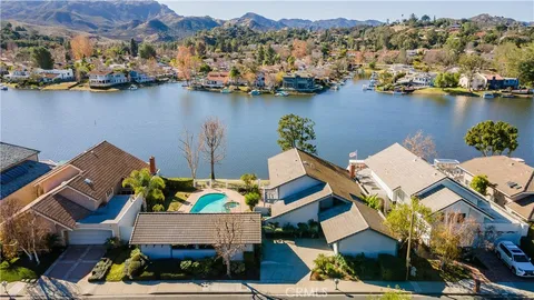 an aerial view of a house with a lake view