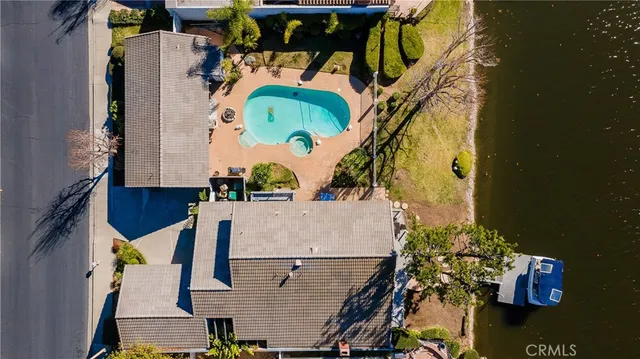 an aerial view of residential house with outdoor space and swimming pool
