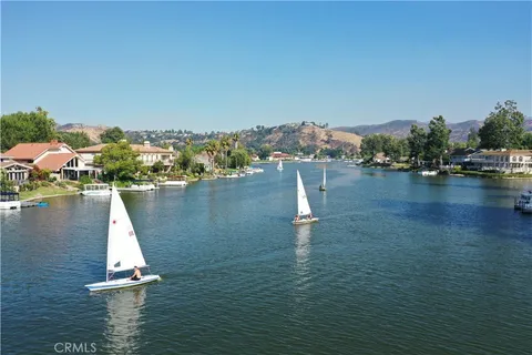an aerial view of lake and residential houses with outdoor space
