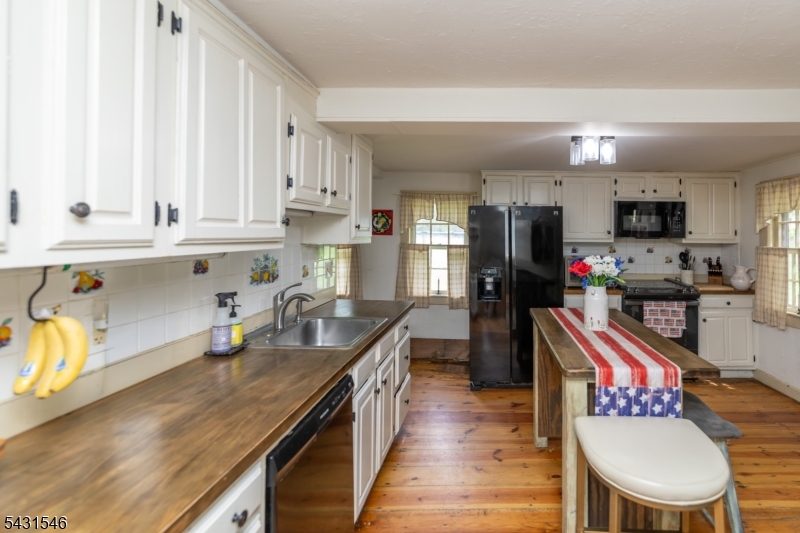 490 Mine Road Asbury, NJ 08802 - Photo 11 of 39 a kitchen with granite countertop a sink stove and cabinets