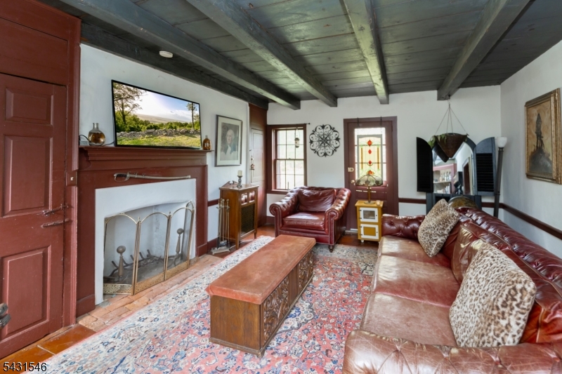 490 Mine Road Asbury, NJ 08802 - Photo 20 of 39 a living room with furniture a flat screen tv and a fireplace