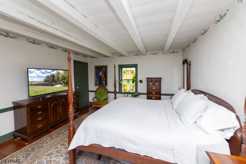 490 Mine Road Asbury, NJ 08802 - Photo 24 of 39 a bedroom with a bed and a flat screen tv