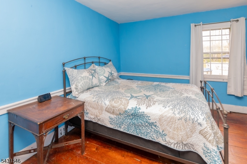 490 Mine Road Asbury, NJ 08802 - Photo 25 of 39 a bed sitting in a bedroom next to a window