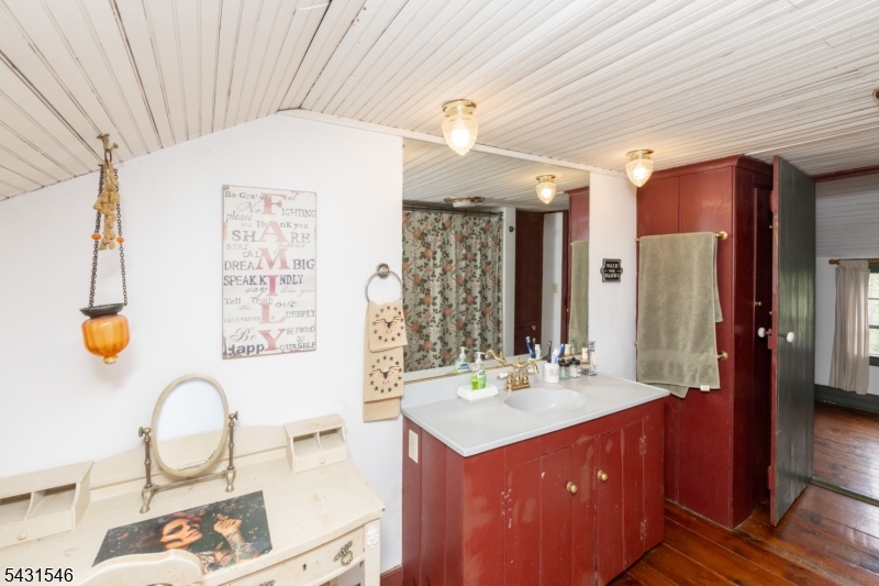 490 Mine Road Asbury, NJ 08802 - Photo 28 of 39 a bathroom with a sink a vanity and a mirror