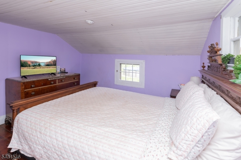 490 Mine Road Asbury, NJ 08802 - Photo 30 of 39 a bedroom with a bed and a flat screen tv